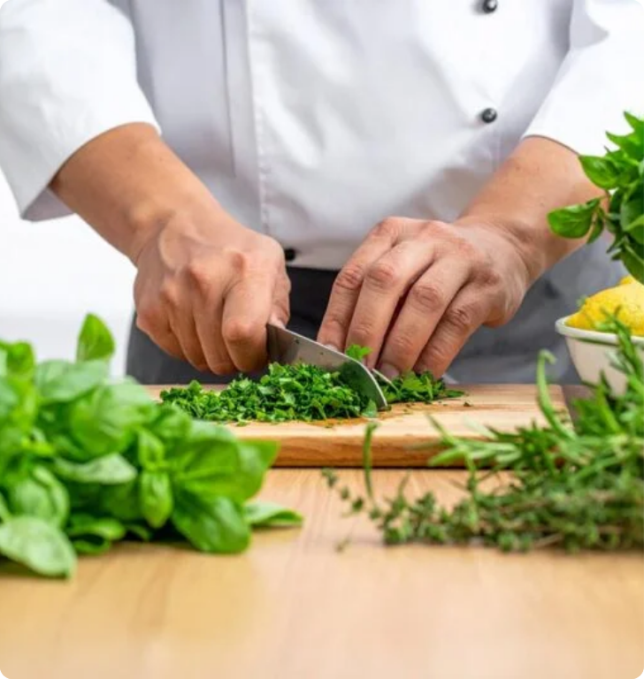 Chef chopping fresh herbs